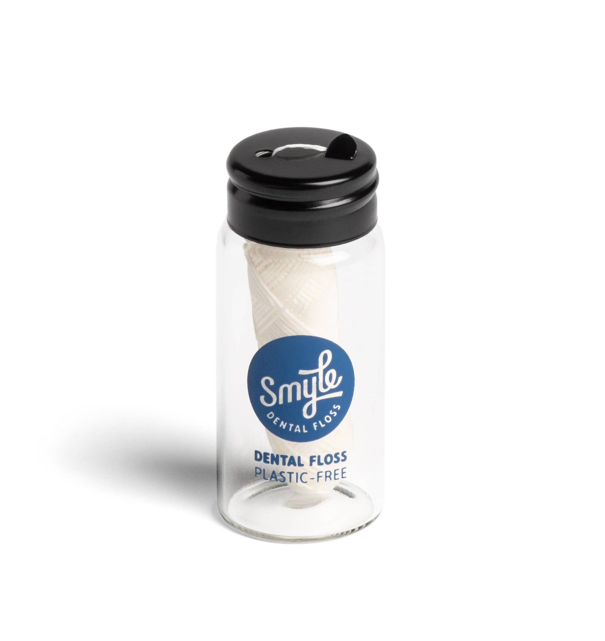 Komposterbar tanntråd laget av maisbasert PLA i refillbar glassbeholder – plastfritt, vegansk og miljøvennlig alternativ til vanlig tanntråd.